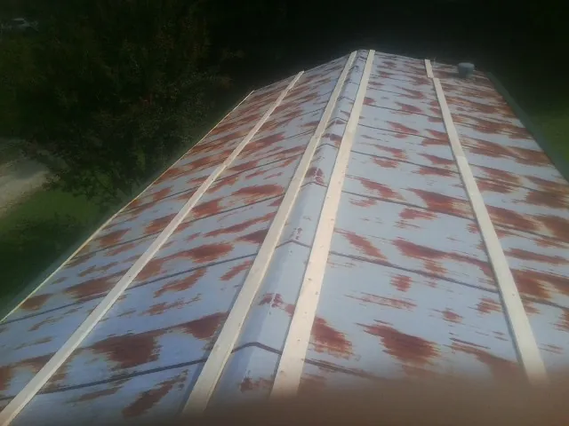 Rusted metal roof panels with new wood purlins before replacement — Storm Damage Roof Repair in Welaka by Roofing Brothers